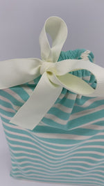 Load and play video in Gallery viewer, small fabric gift bag in turquoise and white stripe pattern with a ribbon
