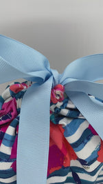 Load and play video in Gallery viewer, Pink and orange flowers and blue stripes reusable and sustainable gift bag in size medium with a blue ribbon video
