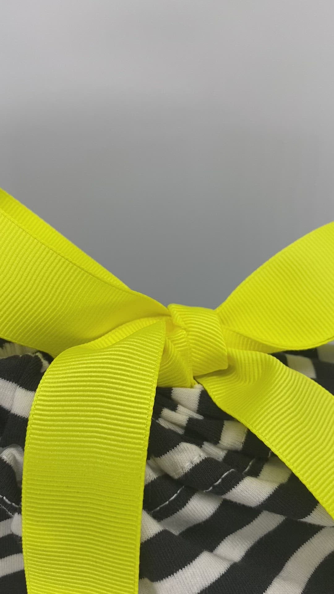 Medium black and white stripes reusable and sustainable fabric gift bag with yellow ribbon