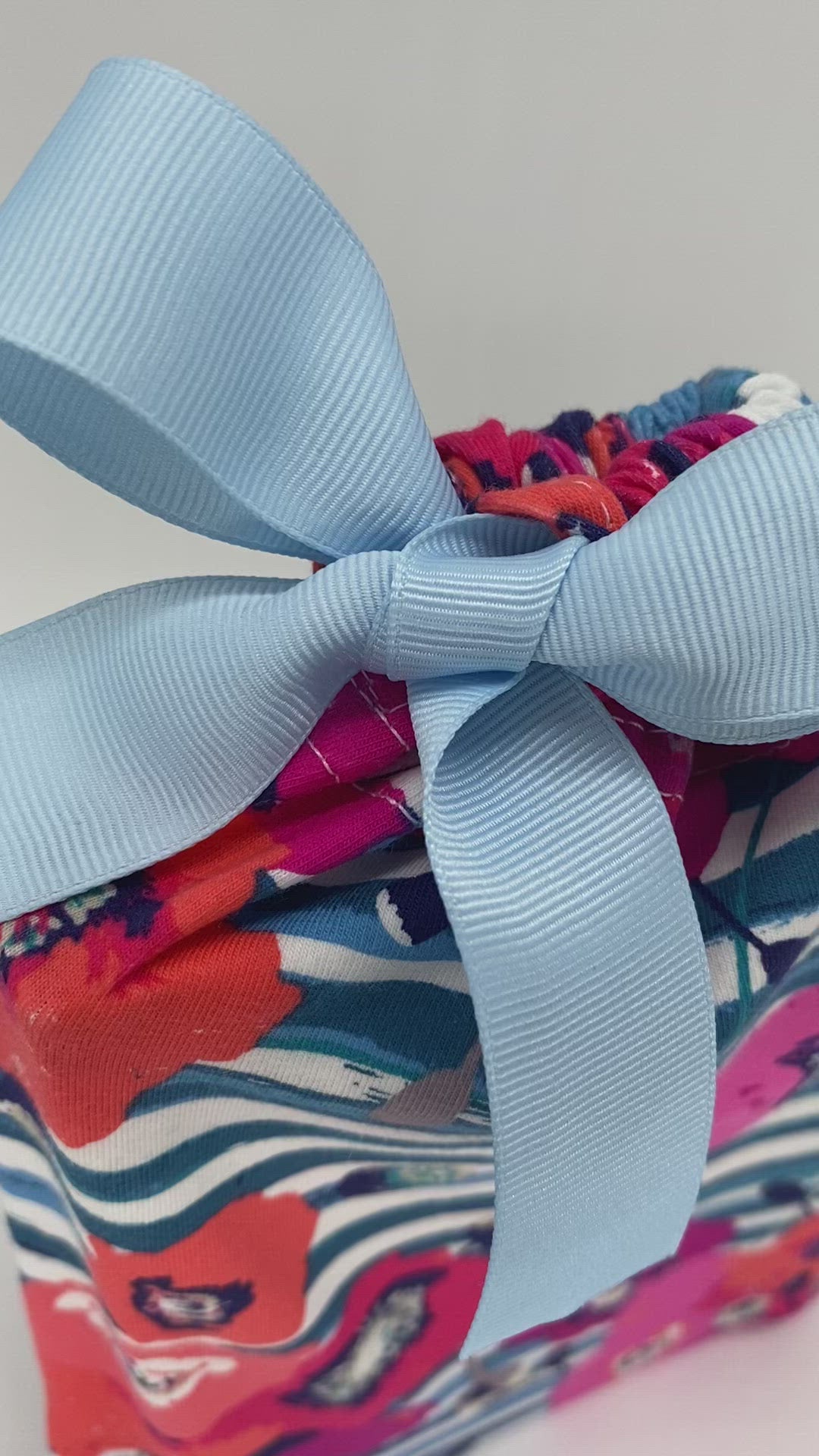 pink and orange flowers and blue stripes small reusable fabric gift bag with a ribbon