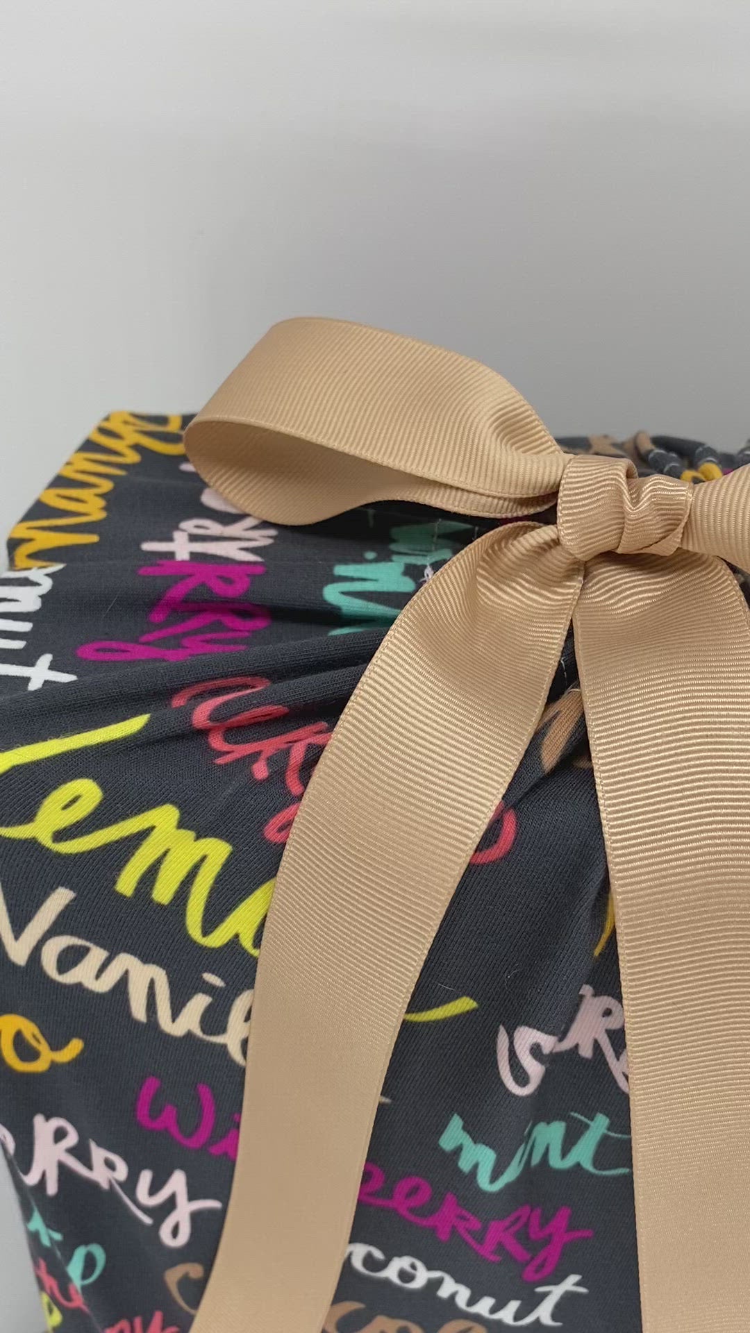  large sustainable and ruble fabric gift bag with colorful ice-cream names on it and a ribbon video 