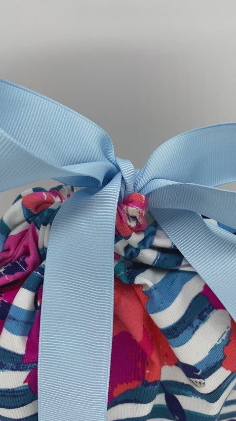 Pink and orange flowers and blue stripes reusable and sustainable gift bag in size medium with a blue ribbon video
