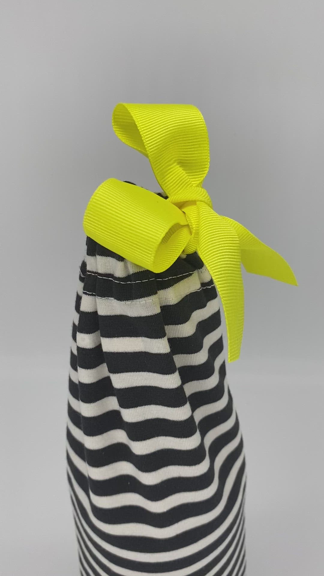wine fabric gift bag in black and white stripes with a yellow ribbon