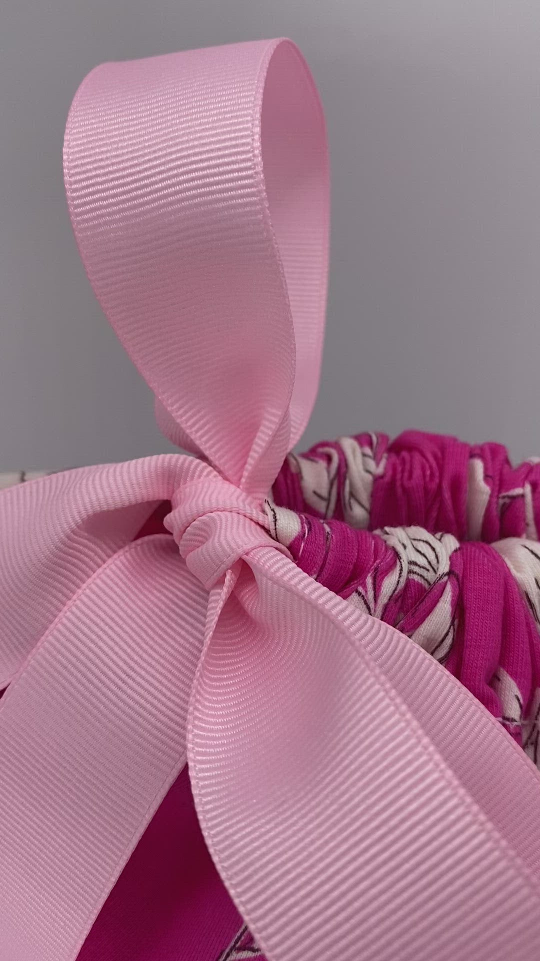 Medium size pink and white flowers reusable and sustainable fabric gift bag with pink ribbon video