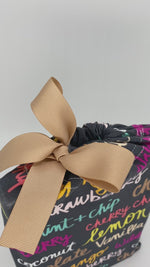 Load and play video in Gallery viewer, video of small fabric gift bag with colorful ice-cream names on it and a ribbon
