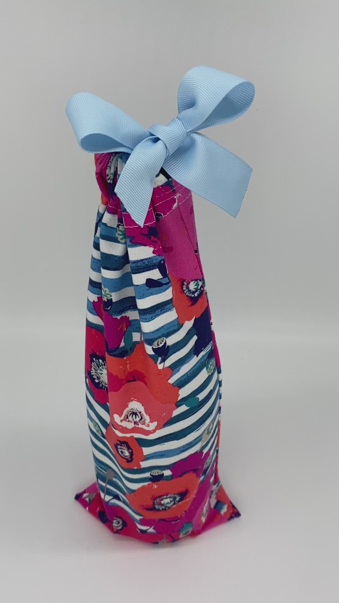 pink and orange flowers and blue stripes fabric wine gift bag with a ribbon